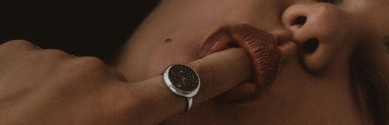 vrouw-die-haar-vinger-in-haar-mond-heeft